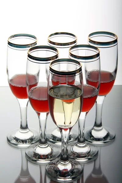 Wine goblets on mirror table — Stock Photo, Image
