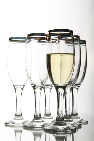 Wine goblets on mirror table — Stock Photo, Image