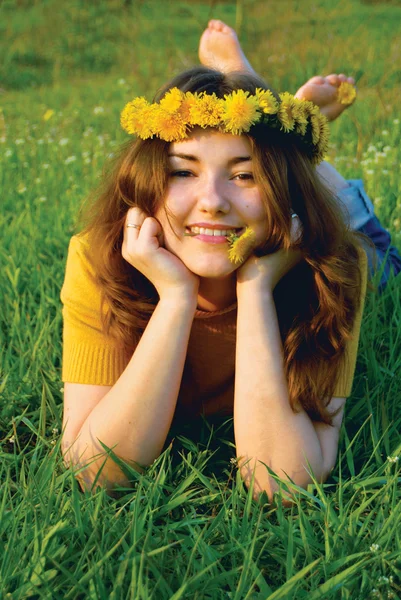 Girl in a wreatht from dandelions — Stock Photo, Image