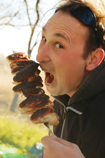 stock image A man eating up meat