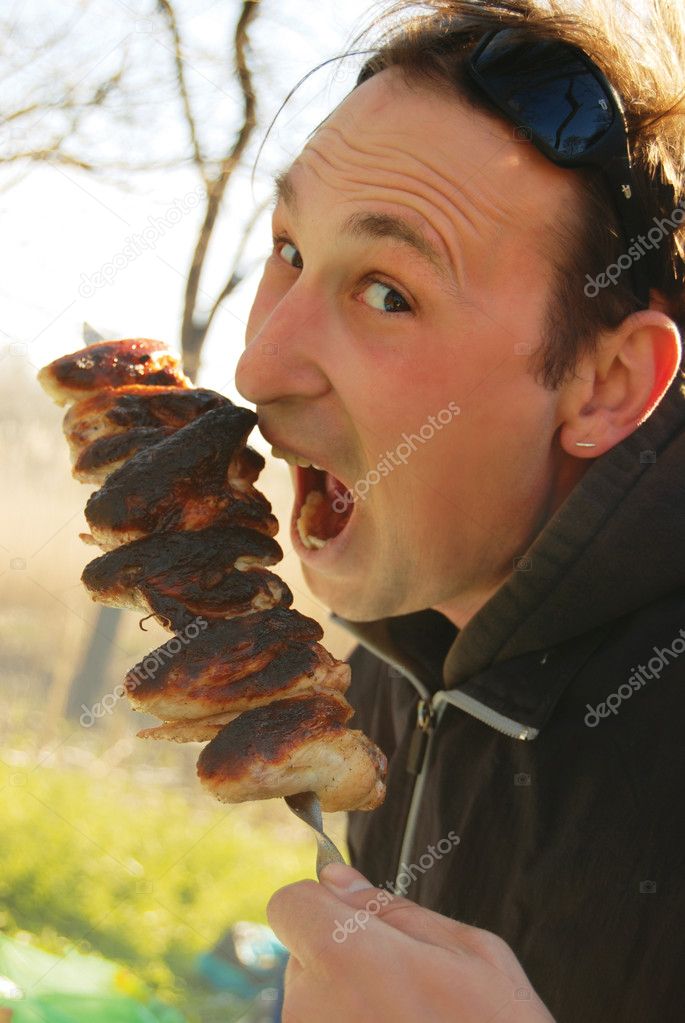 A man eating up meat