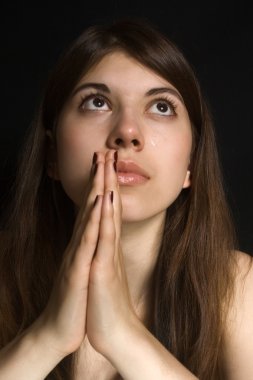 Portrait of a praying girl. clipart