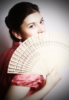 Portrait of the girl with a fan. clipart