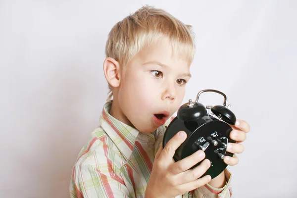 The boy a showing alarm clock. — Stock Photo, Image