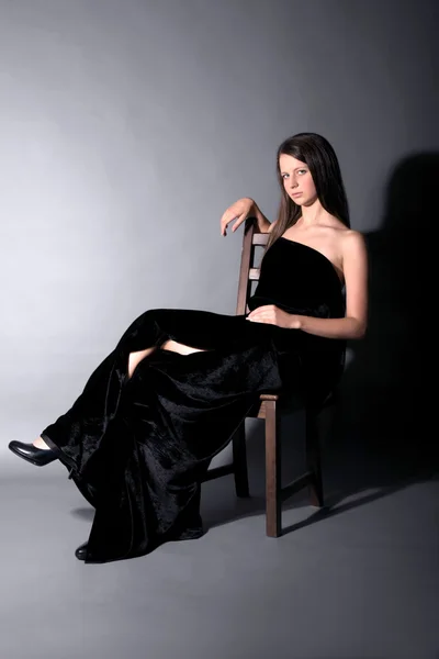 Beautiful girl sit on stool — Stock Photo, Image