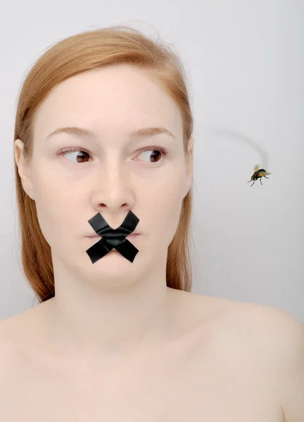 stock image Young woman with the closed mouth