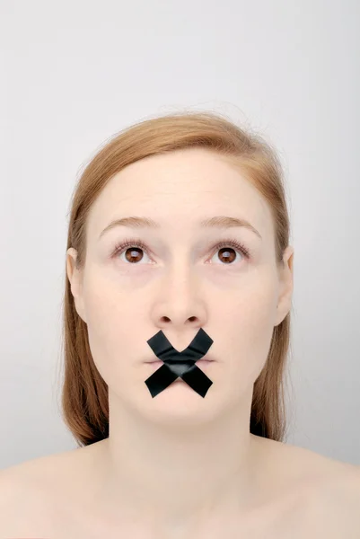 stock image Young woman with the closed mouth