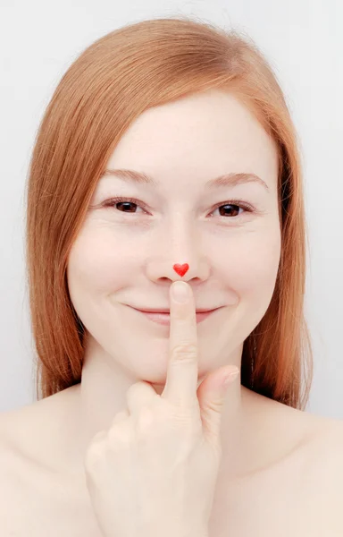 Young woman with heart on nose — Stock Photo, Image