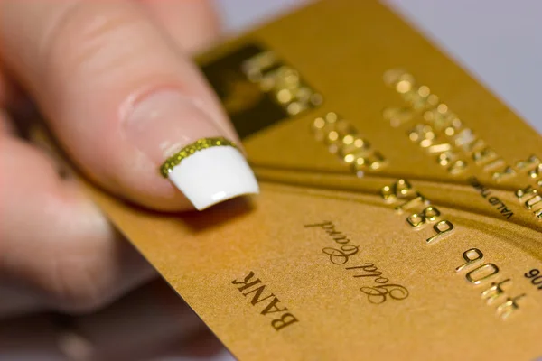 Cartão bancário de ouro no braço — Fotografia de Stock