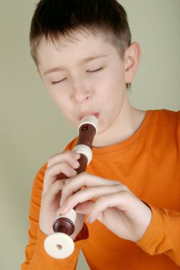 The boy playing the flute clipart