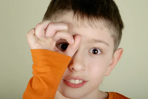 Boy looking through a hand — Stock Photo, Image