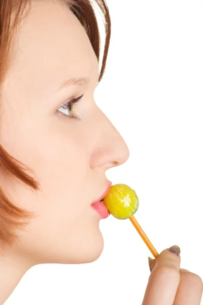 Sucks a lollipop candy — Stock Photo, Image