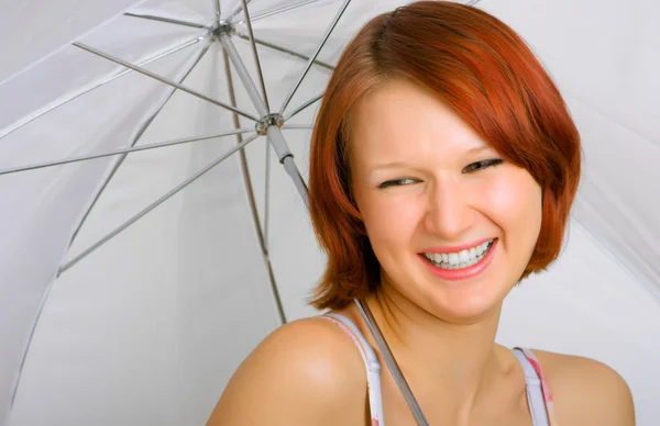 With a smile under an umbrella — Stock Photo, Image