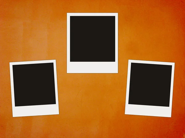 Three instant photos on vintage red — Stock Photo, Image