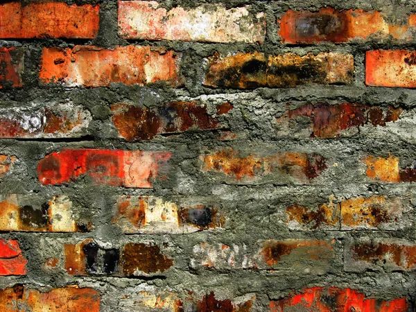 Kleurrijke verbrande bakstenen muur achtergrond — Stockfoto