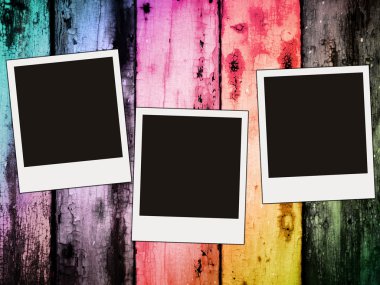 Three blank photos on colorful wooden ba clipart