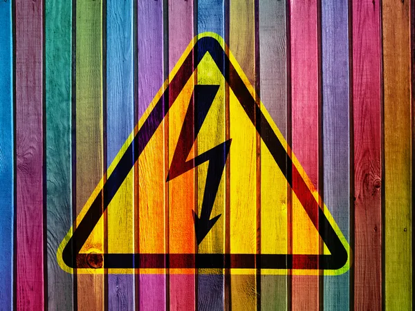High voltage on colorful wooden wall — Stock Photo, Image