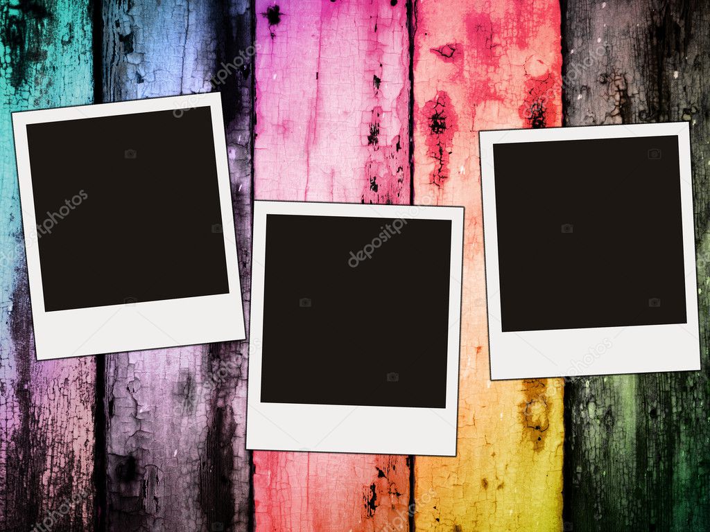 Three blank photos on colorful wooden ba