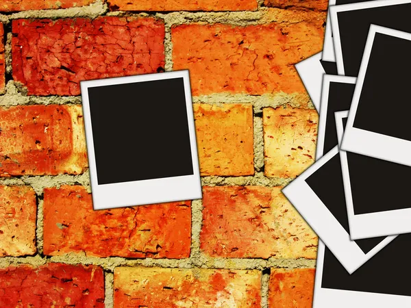 Brick wall with blank photos on it — Stock Photo, Image