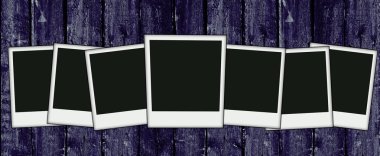 Wooden wall with blank photos clipart