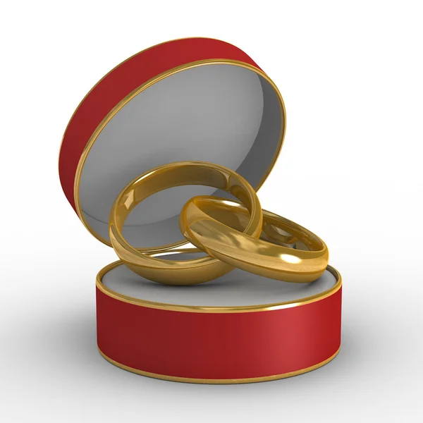 Caixão vermelho com duas alianças de casamento — Fotografia de Stock
