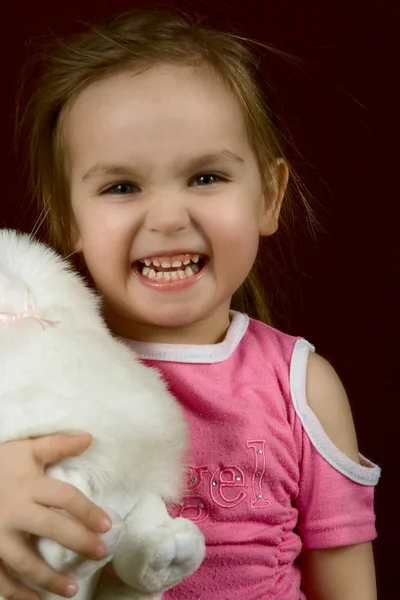 stock image The small artful girl with a toy