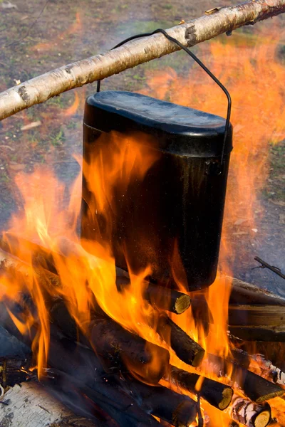 stock image Cooking in a kettle on a fire.