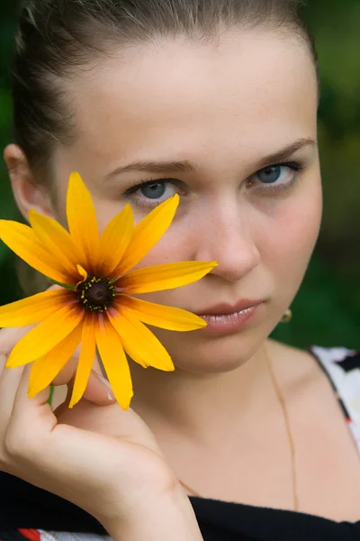 stock image The young girl with a yellow flower