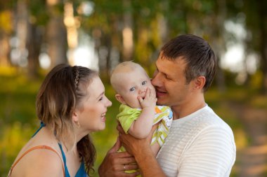 Young happy family in wood clipart