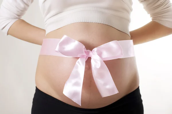 Mujer embarazada con lazo rosa — Foto de Stock