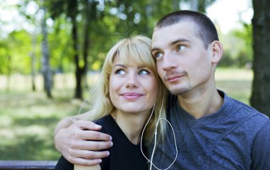 Couple in love sharing a song clipart