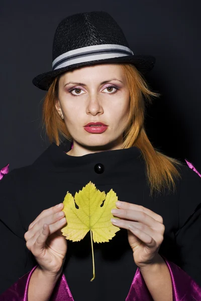 Woman wearing hat with leaf — Stock Photo, Image