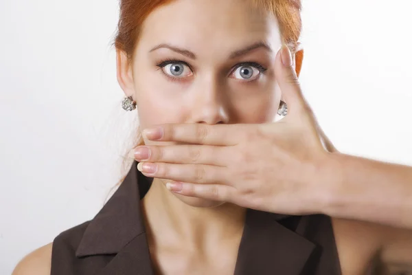 Woman covering mouth with hand — Stock Photo, Image