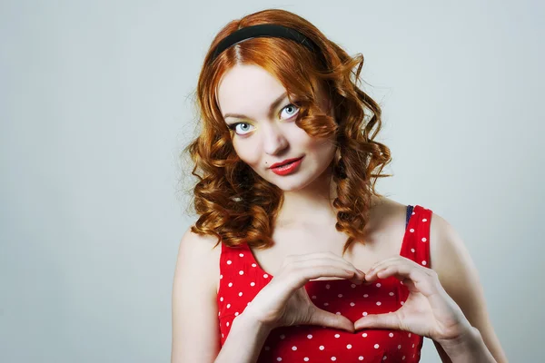 Woman with heart shaped fingers — Stock Photo, Image