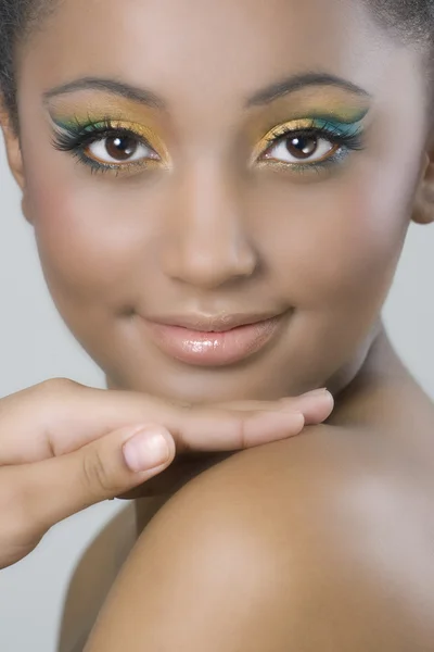 Colourful makeup on dark skinned beauty Stock Image