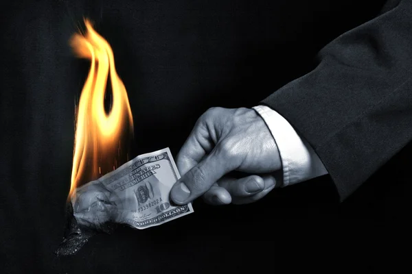 The burning dollar in a hand — Stock Photo, Image