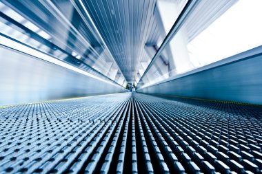 Close-up of moving escalator in blue clipart