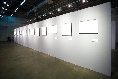 White wall with many empty frames clipart