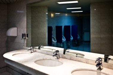 Empty restroom interior with washstands clipart