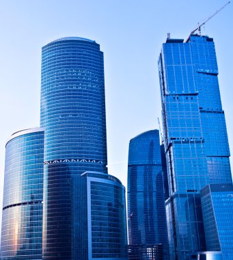 Blue modern skyscrapers in business cent clipart