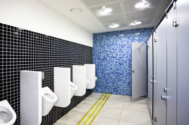 Public toilet with cubicles and urinals clipart