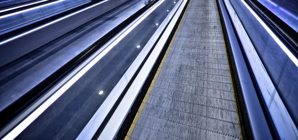 Empty blue moving escalator — Stok fotoğraf
