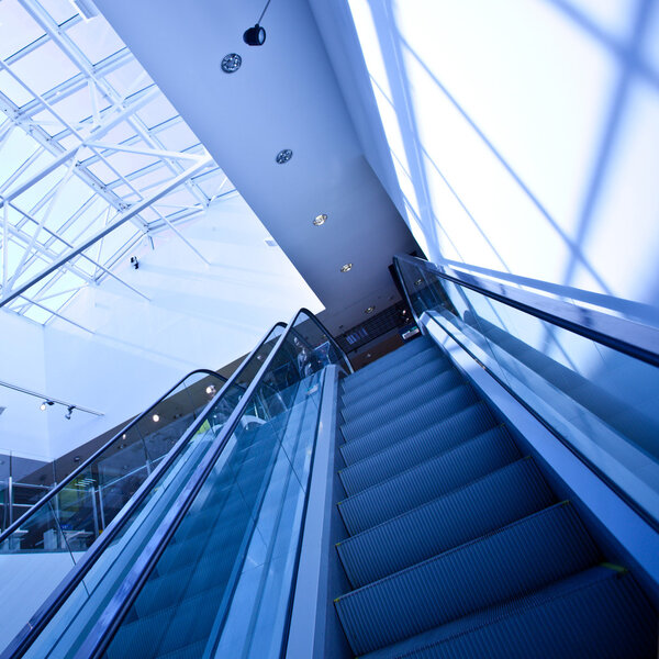 Escalator in blue corridor in office centre