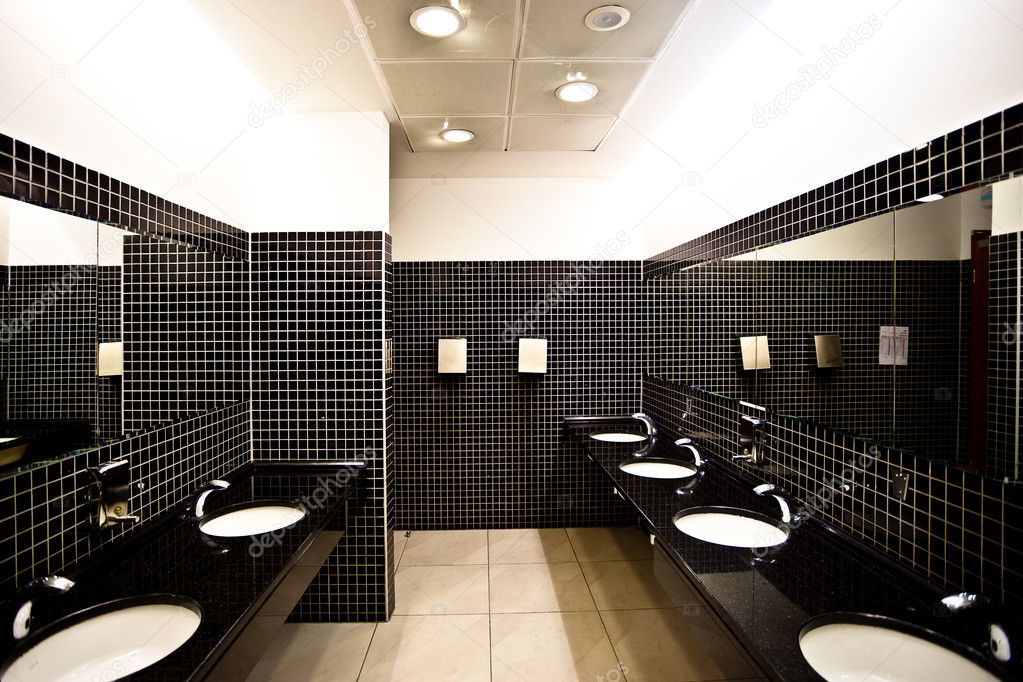 Empty restroom interior with washstands,