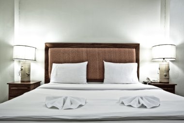 Hotel bedroom interior with pillows and clipart