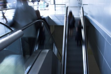 Moving crowd on escalator clipart