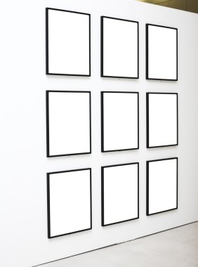 Nine empty frames on white wall