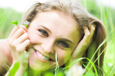 Girl lays on grass clipart