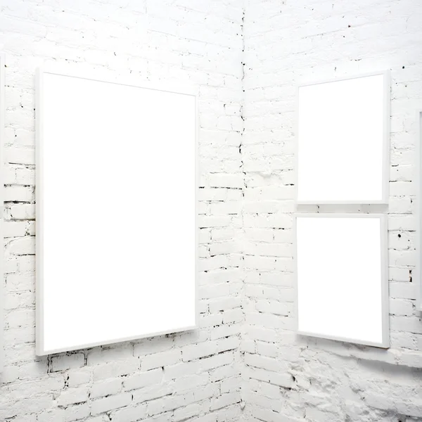 Brick wall in museum with frames — Stock Photo, Image