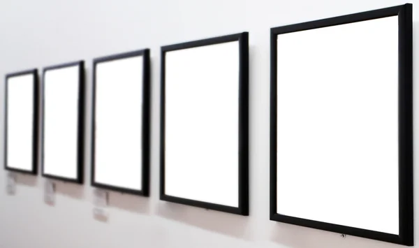 Empty frames on white wall — Stock Photo, Image